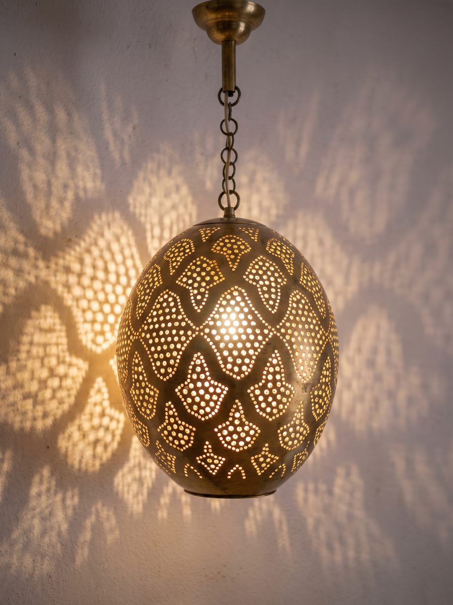 Hand-pierced pendant casting dotted light